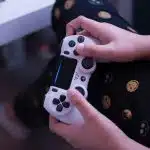 person holding white sony ps 4 controller