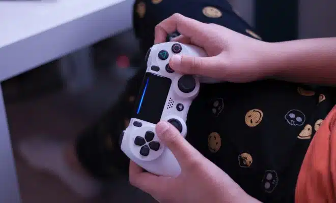 person holding white sony ps 4 controller